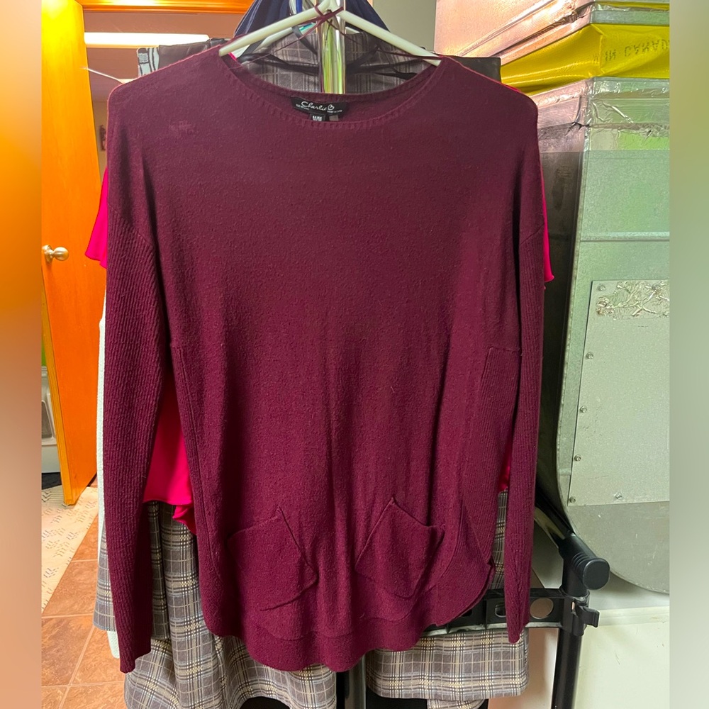 Charley B sweater with two front pockets .